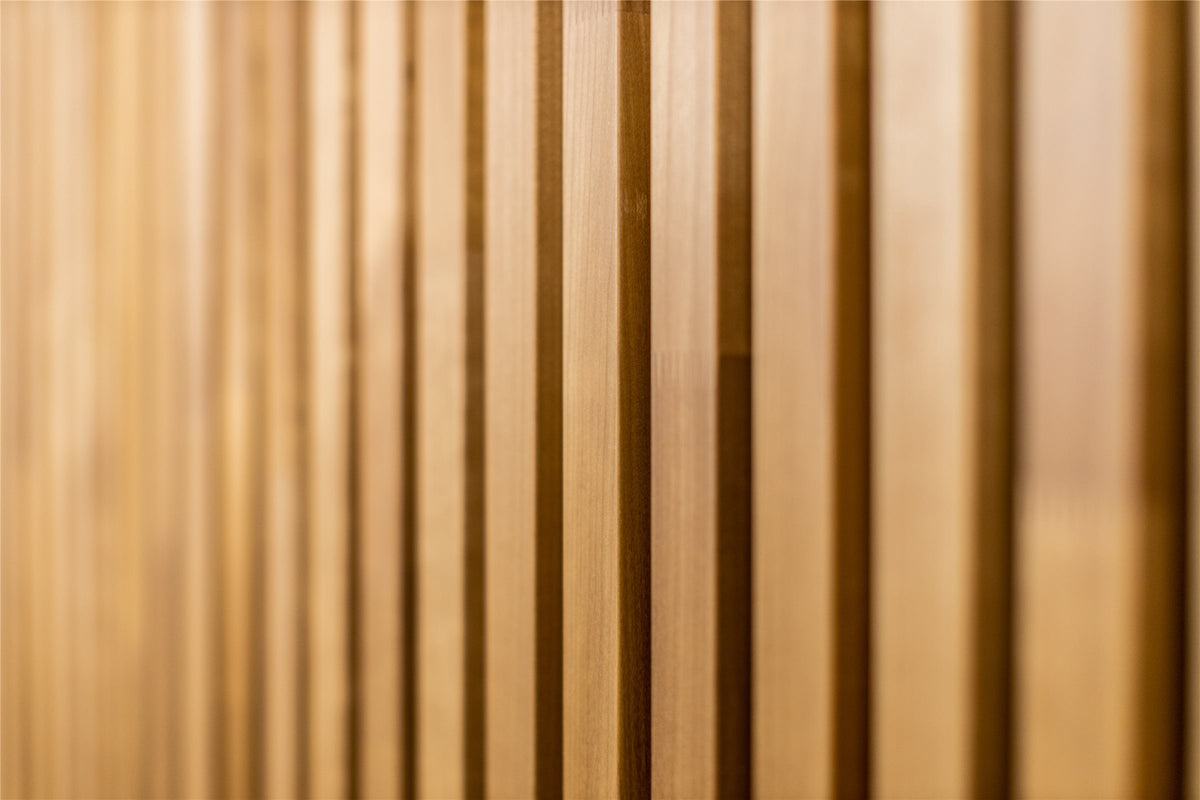 Thermo aspen slats in warm golden brown, soft focus close-up