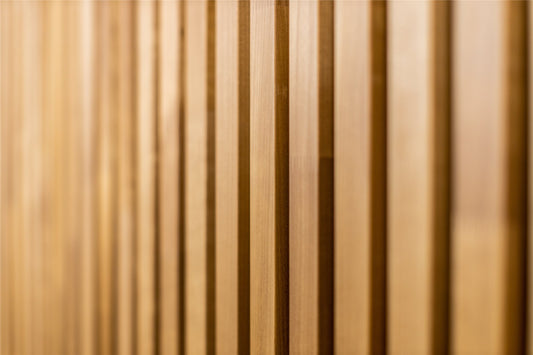 Thermo aspen slats in warm golden brown, soft focus close-up
