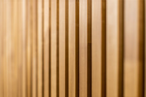 Thermo aspen slats in warm golden brown, soft focus close-up