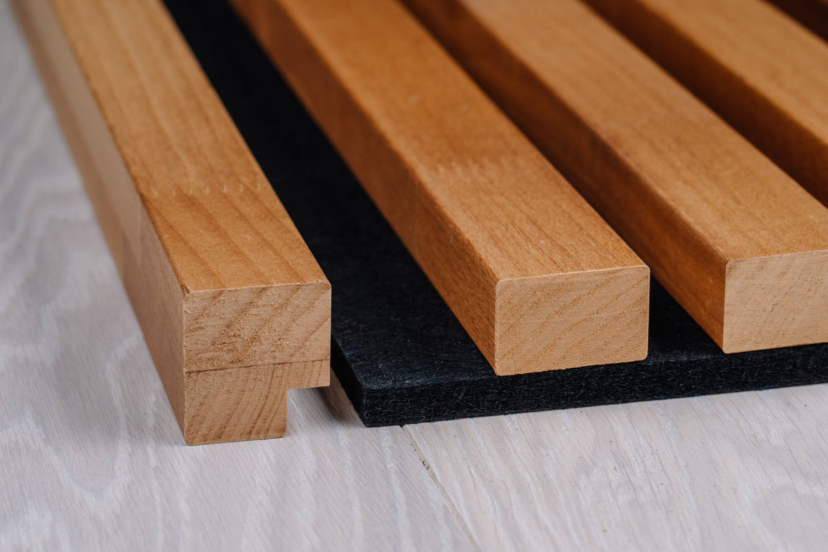 Thermo aspen slats with finger-jointed profile on black felt, side view