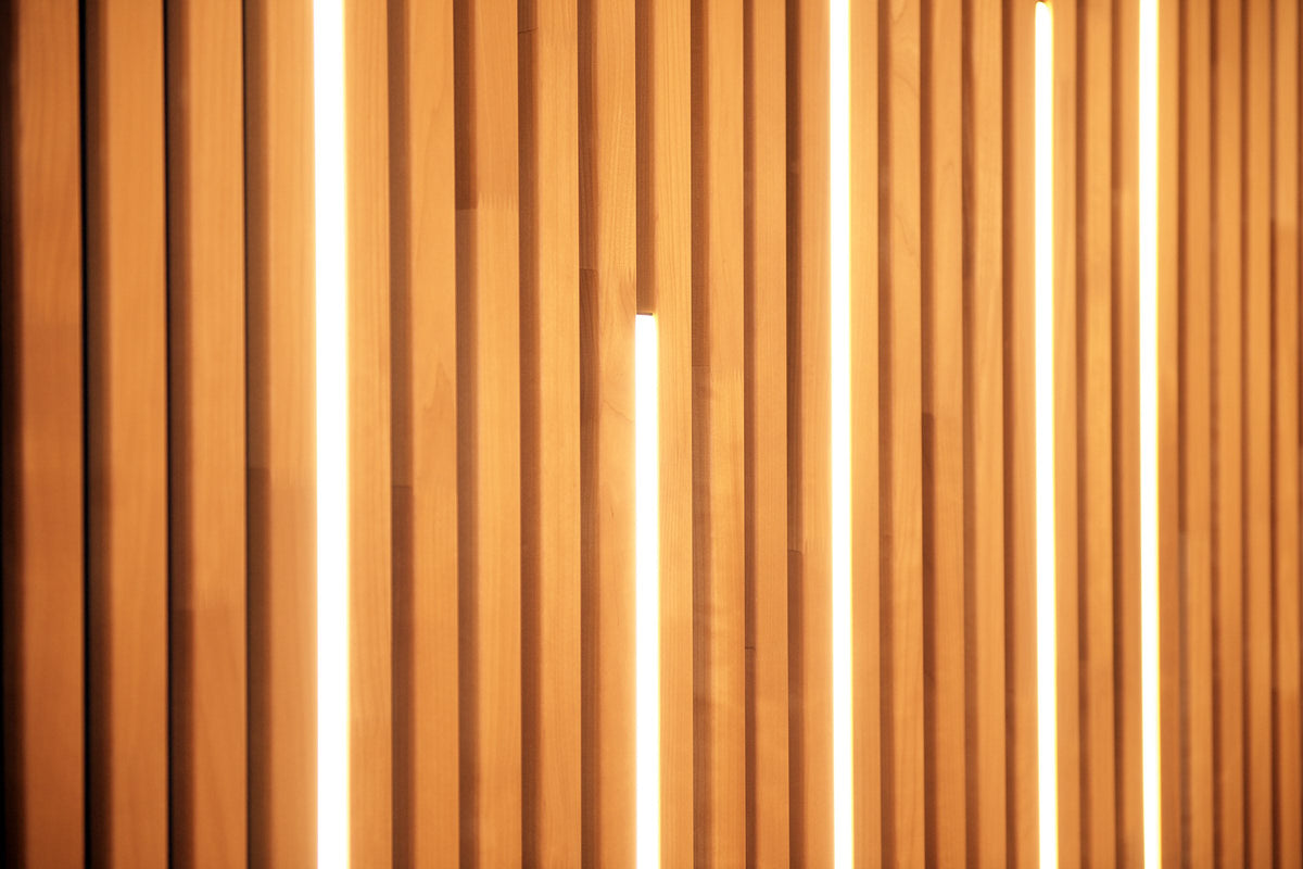 Thermo aspen slat wall with light shining through gaps between slats