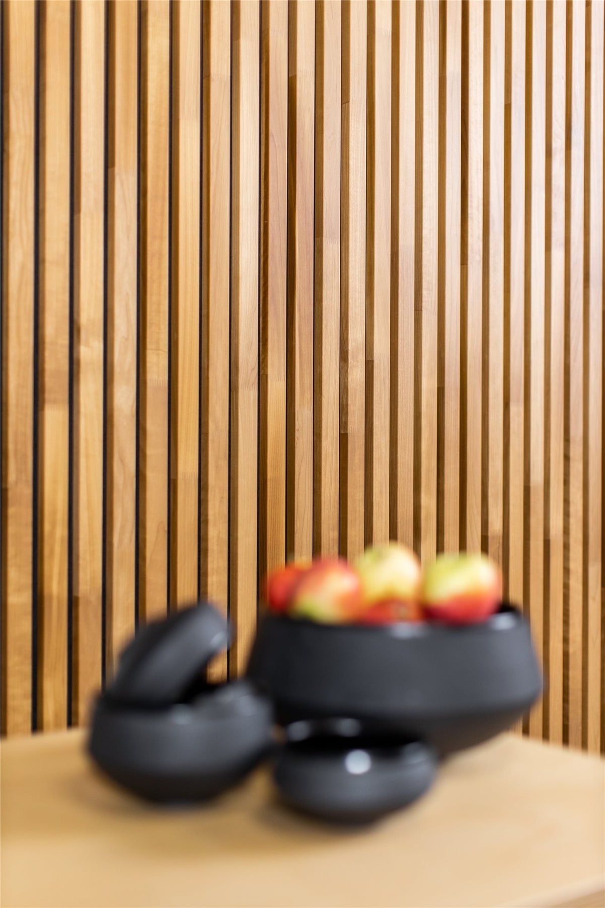 Thermo aspen slat wall behind a kitchen worktop with a black bowl