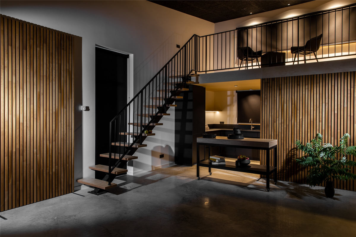 Loft interior with a thermo aspen slat wall beside a staircase