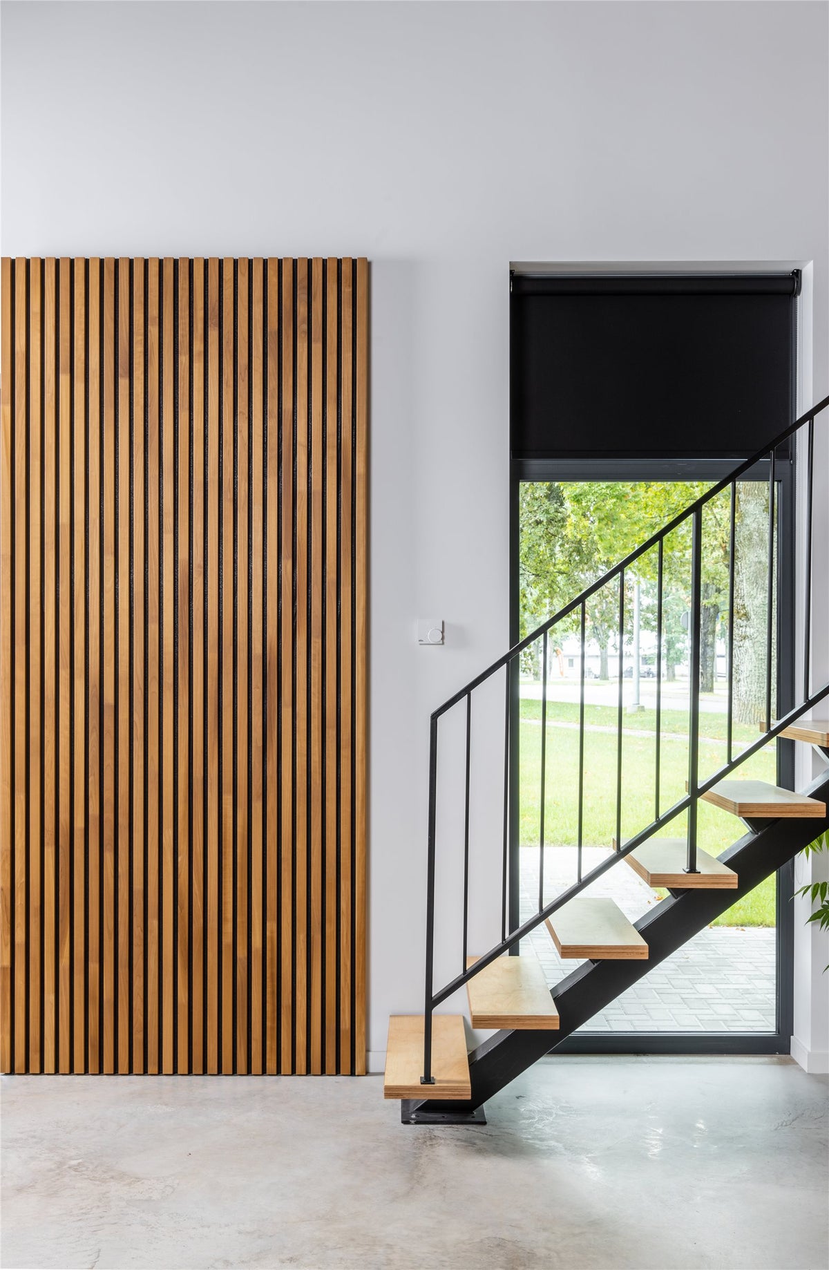 Thermo aspen slat wall beside a staircase and glass door