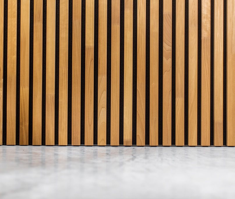 Thermo aspen slat wall panels standing on a polished concrete floor