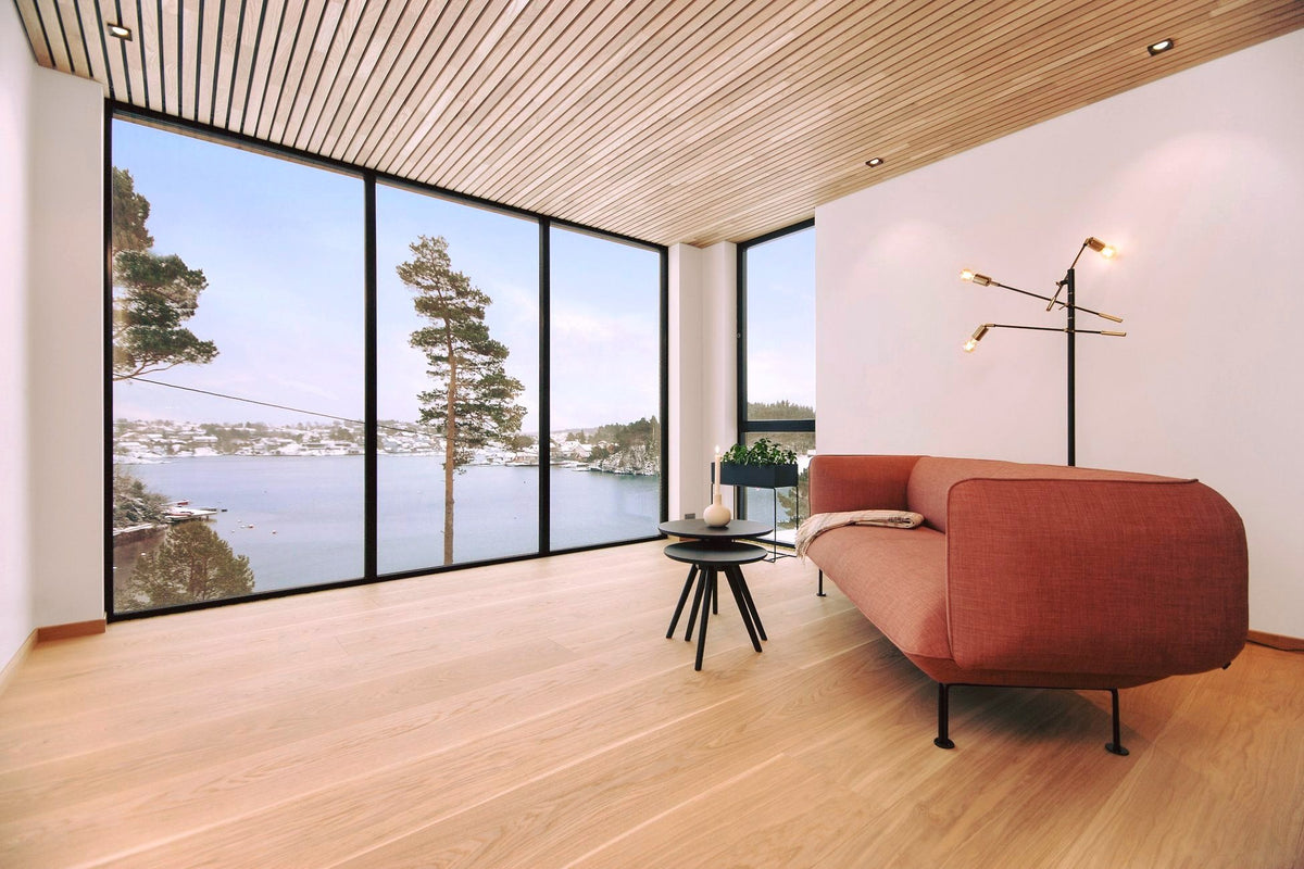 Living room with a thermo aspen slat ceiling and large windows