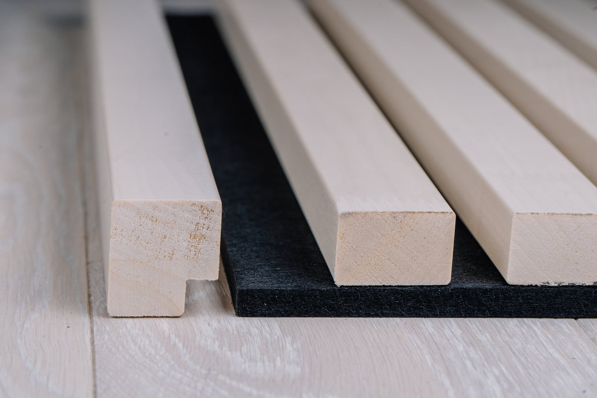 White aspen slat panel edge detail with finger-jointed slats on black felt