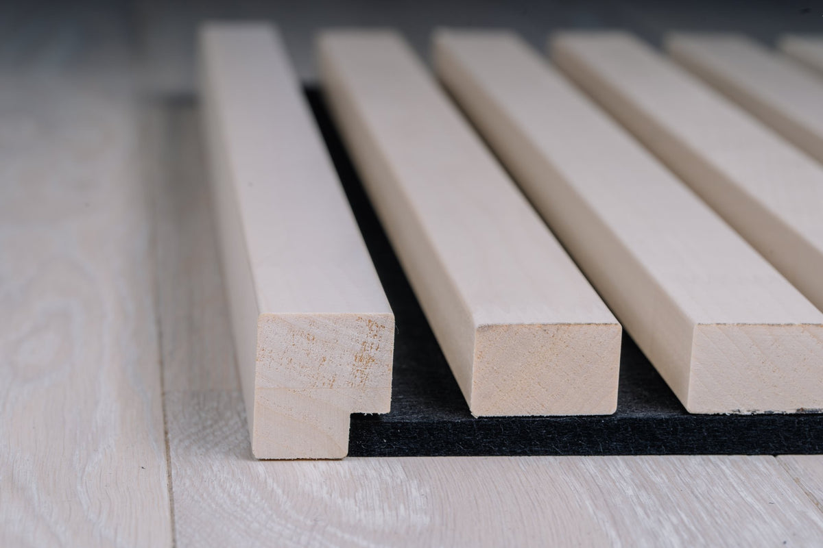 White aspen slats on black felt shown from the panel end