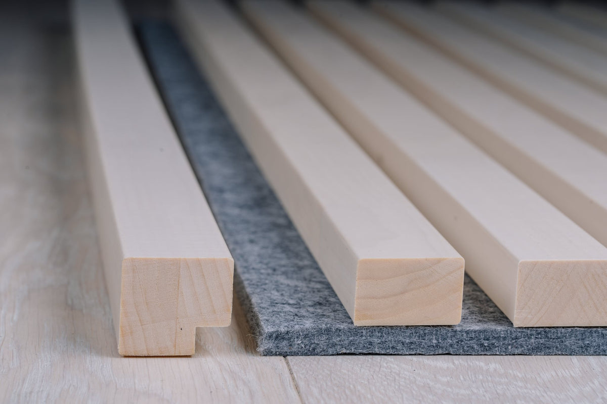 White aspen slats on grey felt with a white end moulding at the panel edge