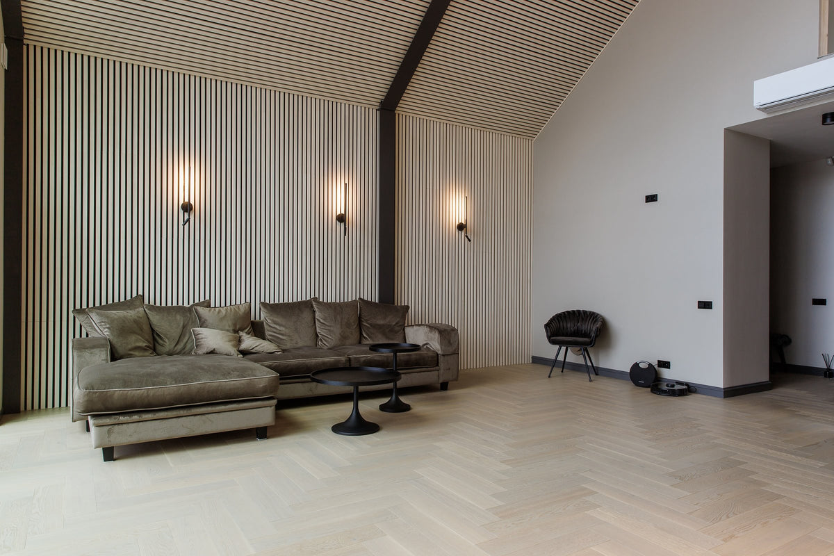 Living room with white aspen slat acoustic wall panels and a herringbone floor