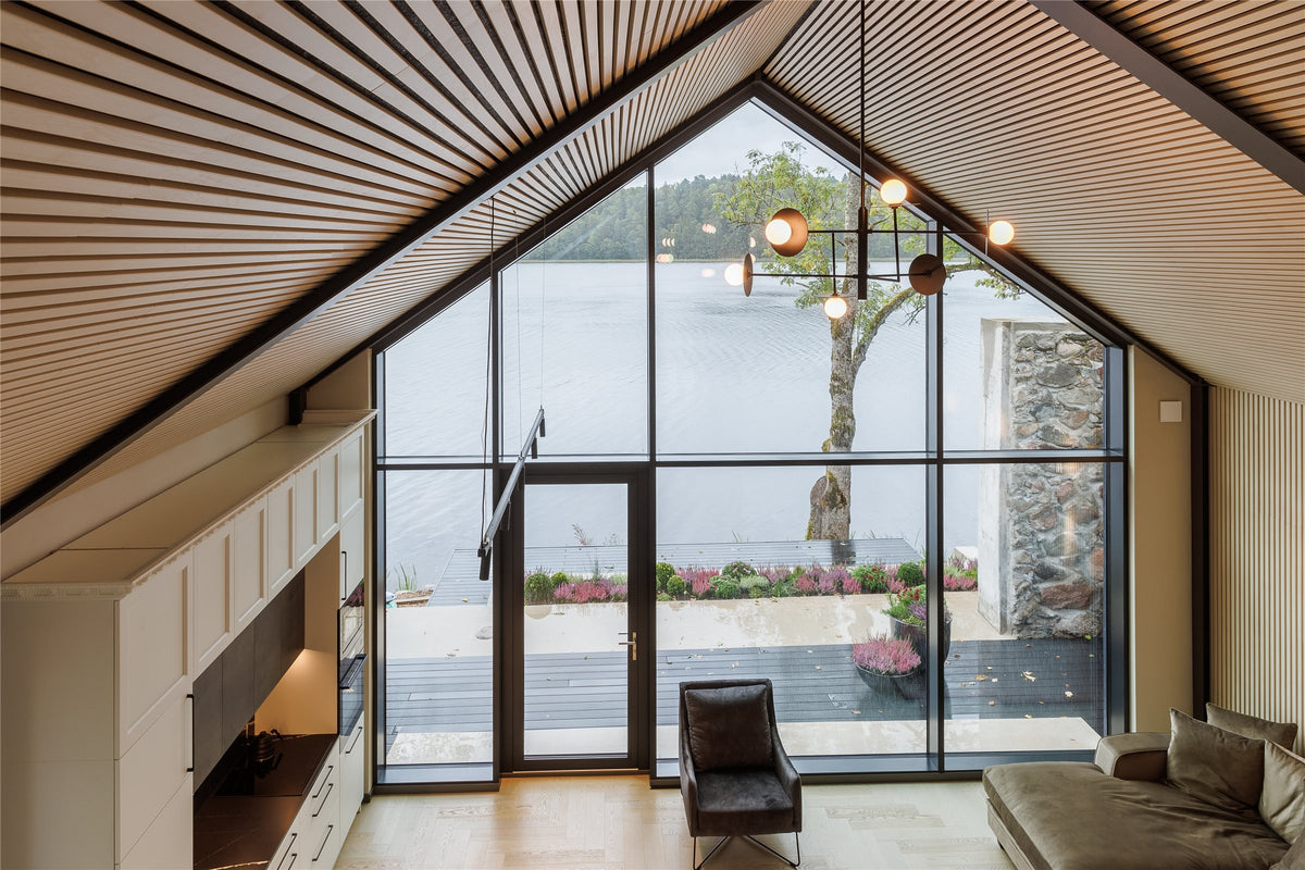 Open living area with a white aspen slat acoustic ceiling and large windows
