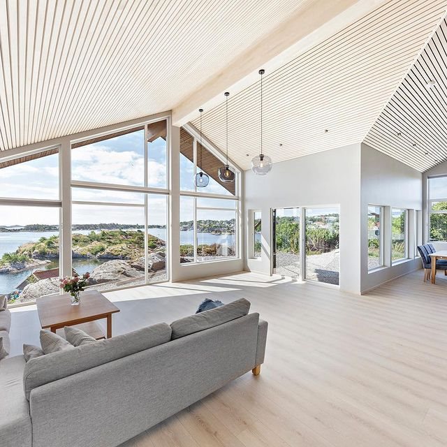 Living room with white slat ceiling and large windows