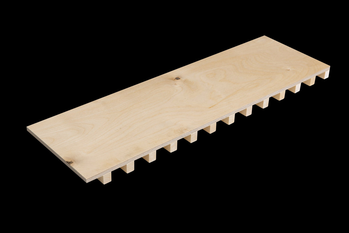 Cutting plate flat side up with the ribs underneath, three-quarter view on a black background