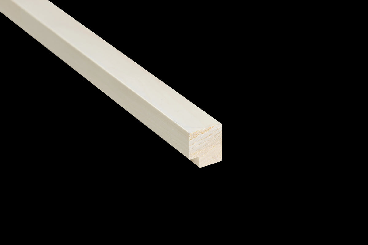 End of a white end moulding showing the notch that covers the felt edge, on a black background