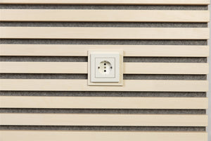 White plate around a wall socket on white aspen slats with grey felt
