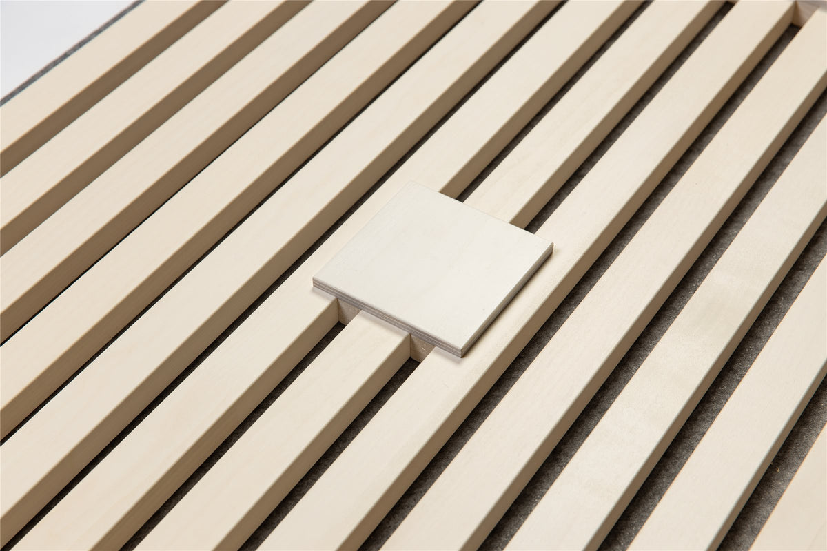 White square plate laid on white aspen slats