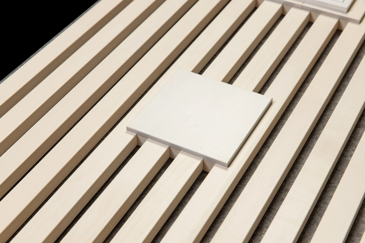 White 15 x 15 cm universal plate laid on white aspen slats, three-quarter view